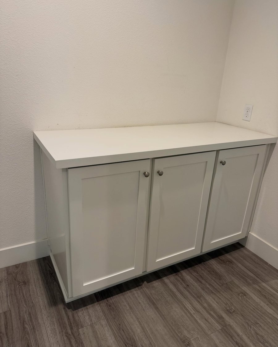 After: the same built-in cabinet painted white