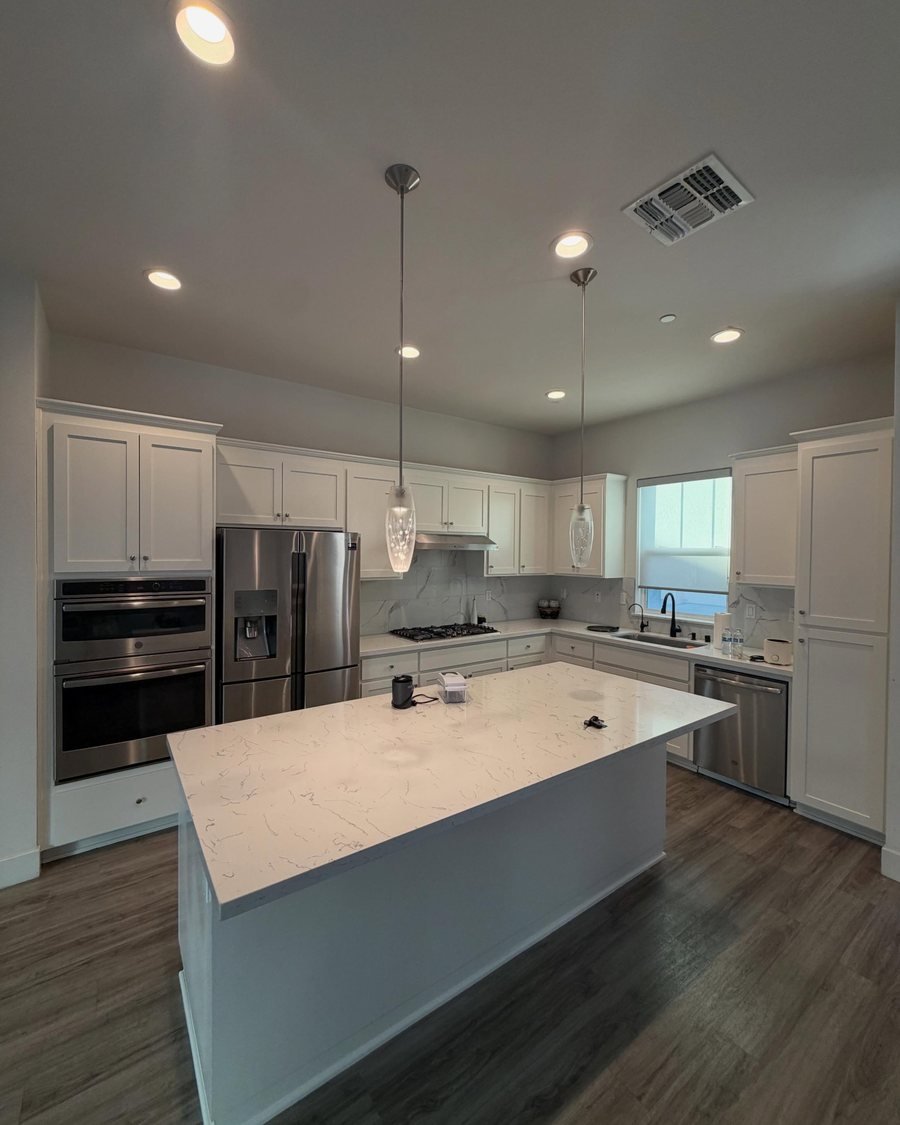 After: the same kitchen with the cabinets and island painted white