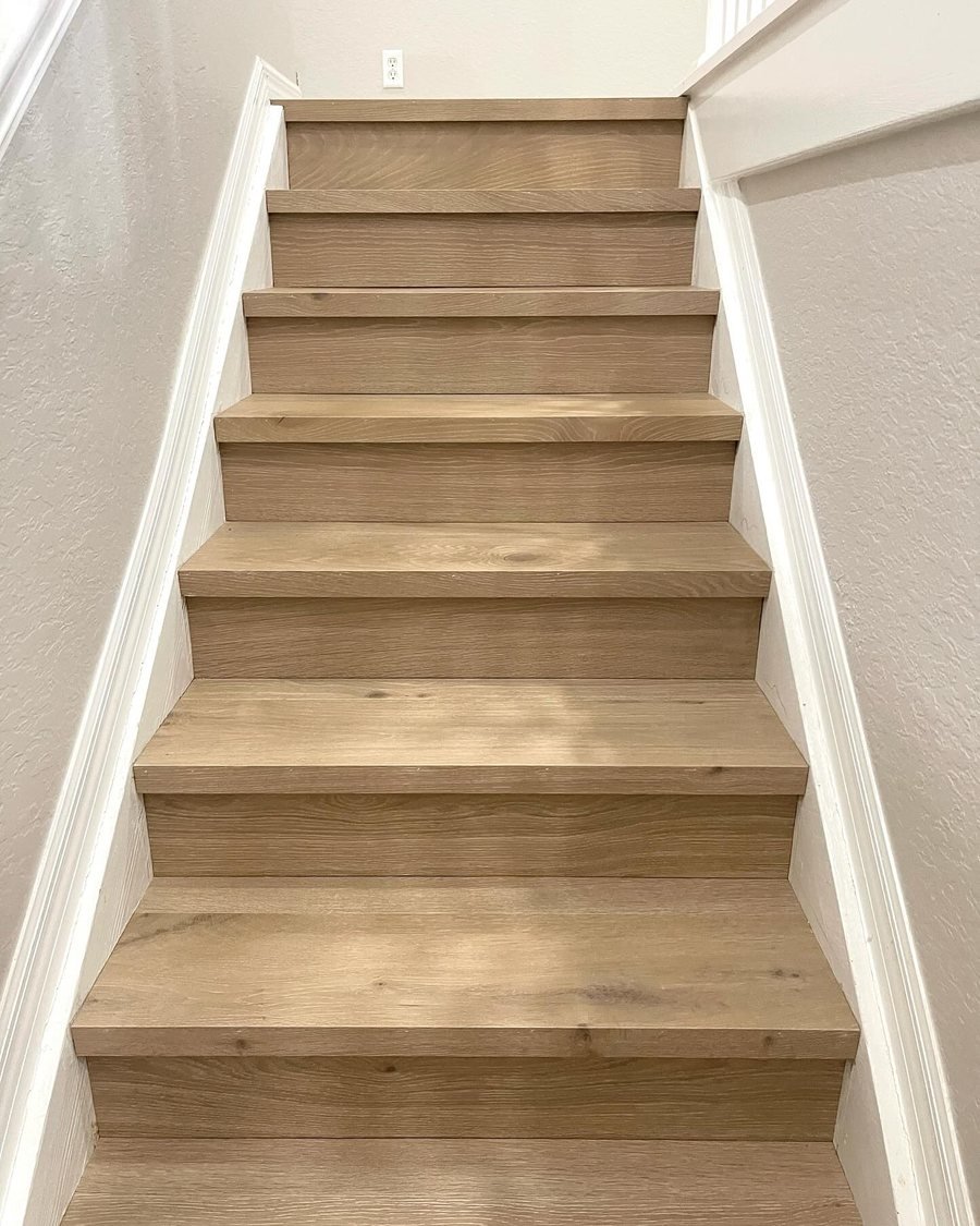 After: the same staircase with light oak-look treads and risers