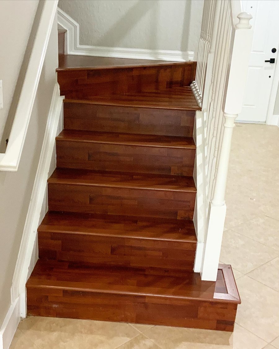 Before: staircase with red-brown laminate treads, risers and bottom step